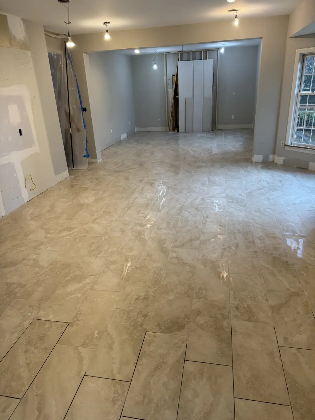 Large-format marble-look tile across an open room